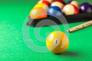 Billiard ball with number 1 on green table, space for text