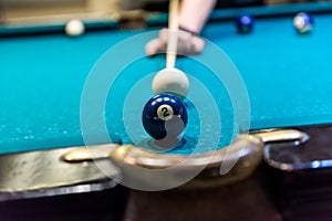 Billiard ball number two near pocket of table