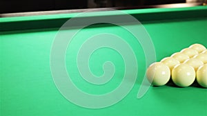 Billiard balls arranged in a triangle. Green table.