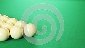 Billiard balls arranged in a triangle. Green table.