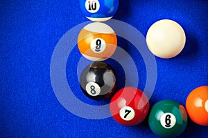 Billiard balls in a blue pool table.