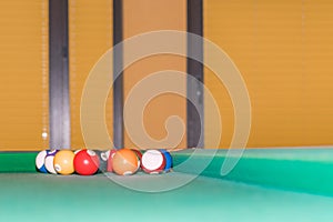 Billiard balls in the corner of the pool table