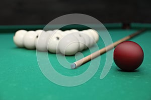 Billiard balls and cue on table
