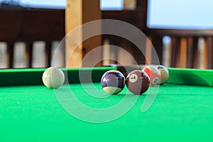 Billiard balls on the green pool table