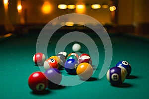 Billiard balls on green table.