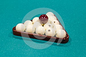 Billiard balls on green table with billiard cue