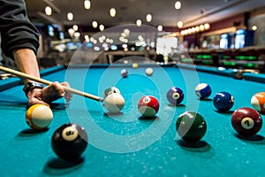 Billiard balls and hand with cue close up