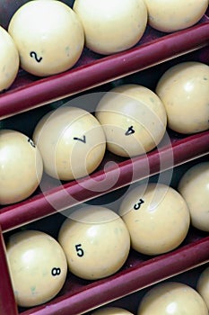 Billiard balls made of ivory on a wooden stock