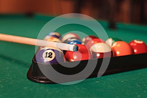 Billiard balls near by cue and chalk.