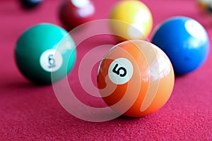 Billiard balls in a pool red table.