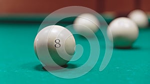 Billiard balls in a pool table. focus on the eight ball