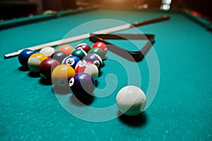 Billiard balls in a pool table at triangle with billiard cue