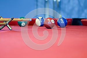 Billiard balls on a red pool table