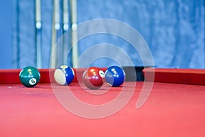 Billiard balls on a red pool table