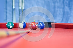 Billiard balls on a red pool table