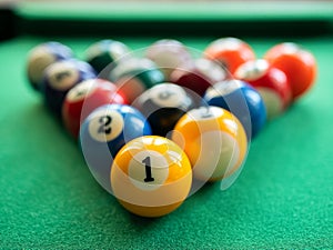Billiard balls are in the triangle on the green table. Concept of billiard, pool or snooker matches