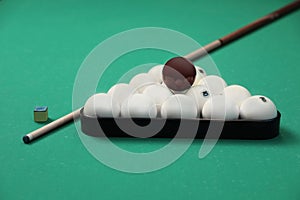 Billiard balls in triangle rack, cue and chalk