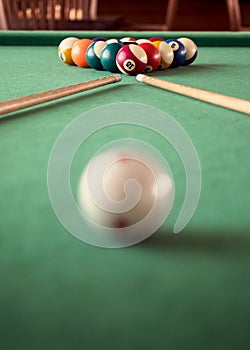 Billiard cues and colored pool balls.