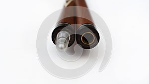 Billiard cues on a white background. Parts of a billiard cue close-up. Live photos of a billiard cue