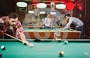 Billiard games - happy friends enjoying playing pool together