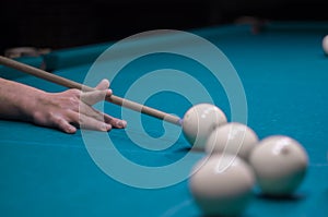 Billiard green table in hall with white balls