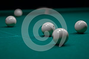 Billiard green table in hall with white balls