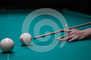 Billiard green table in hall with white balls