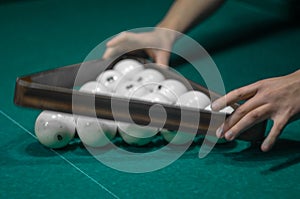 Billiard green table in hall with white balls