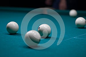 Billiard green table in hall with white balls