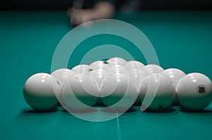 Billiard green table in hall with white balls