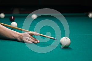 Billiard green table in hall with white balls