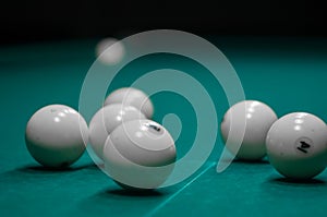 Billiard green table in hall with white balls