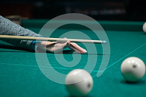 Billiard green table in hall with white balls