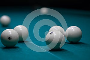 Billiard green table in hall with white balls