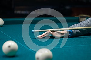 Billiard green table in hall with white balls