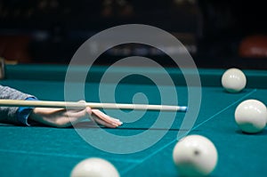 Billiard green table in hall with white balls