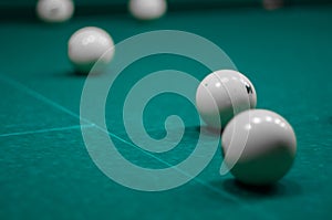 Billiard green table in hall with white balls