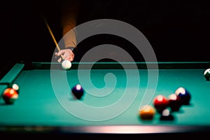 billiard green table in hall with white balls with men hand