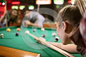 Billiard player aiming on billiard table