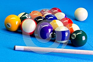 Billiard pool game eight ball setup with cue on billiard table