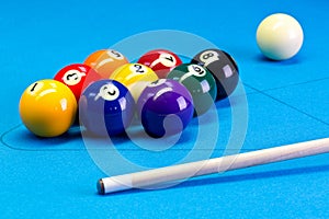 Billiard pool game nine ball setup with cue on billiard table