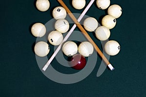 Billiard table with balls, cue, triangle. Green cloth. Playing billiard and pool. Ruusian billiard