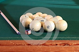 Billiard table with balls, cue, triangle. Green cloth. Playing billiard and pool. Ruusian billiard