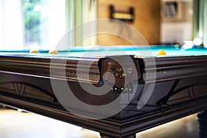 Billiard table close up. Playing billiard. Billiards balls and cue on green billiards table. Billiard sport concept. Pool billiard