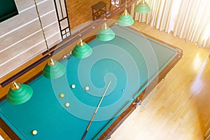 Billiard table close up. Playing billiard. Billiards balls and cue on green billiards table. Billiard sport concept. Pool billiard