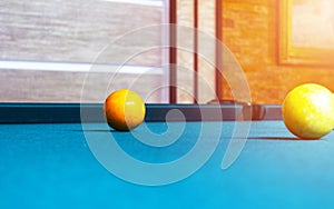 Billiard table close up. Playing billiard. Billiards balls and cue on green billiards table. Billiard sport concept. Pool billiard