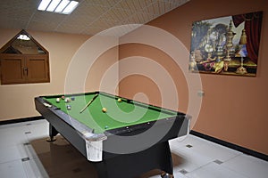 Billiard table with cue and balls. Green billiards background