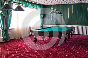 Billiard table with green cloth.