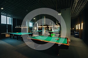 Billiard table with green surface and balls in the billiard club.Pool Game