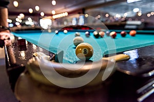 Billiard table with pocket and ball near it